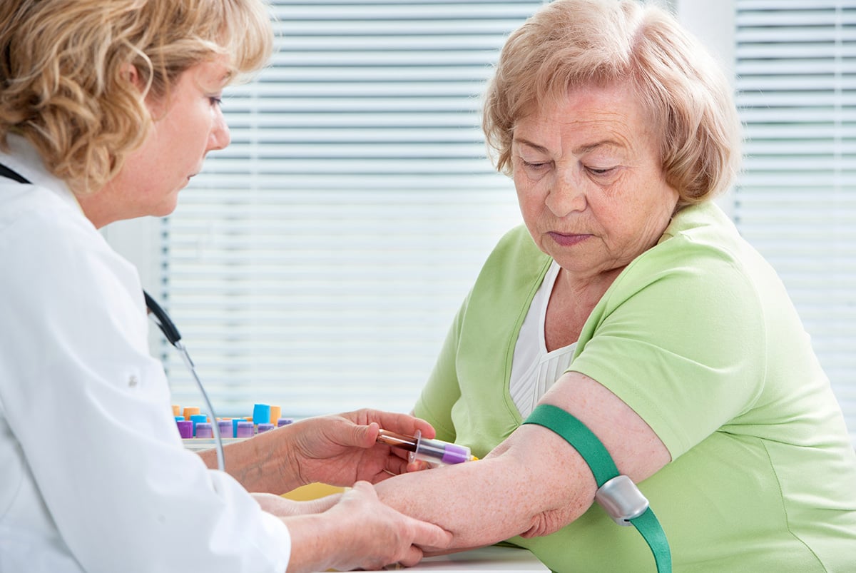 A patient having blood drawn at a clinical site.