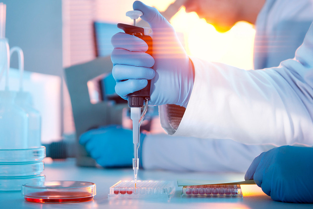 A Champions scientist pipetting during an endpoint analysis assay.